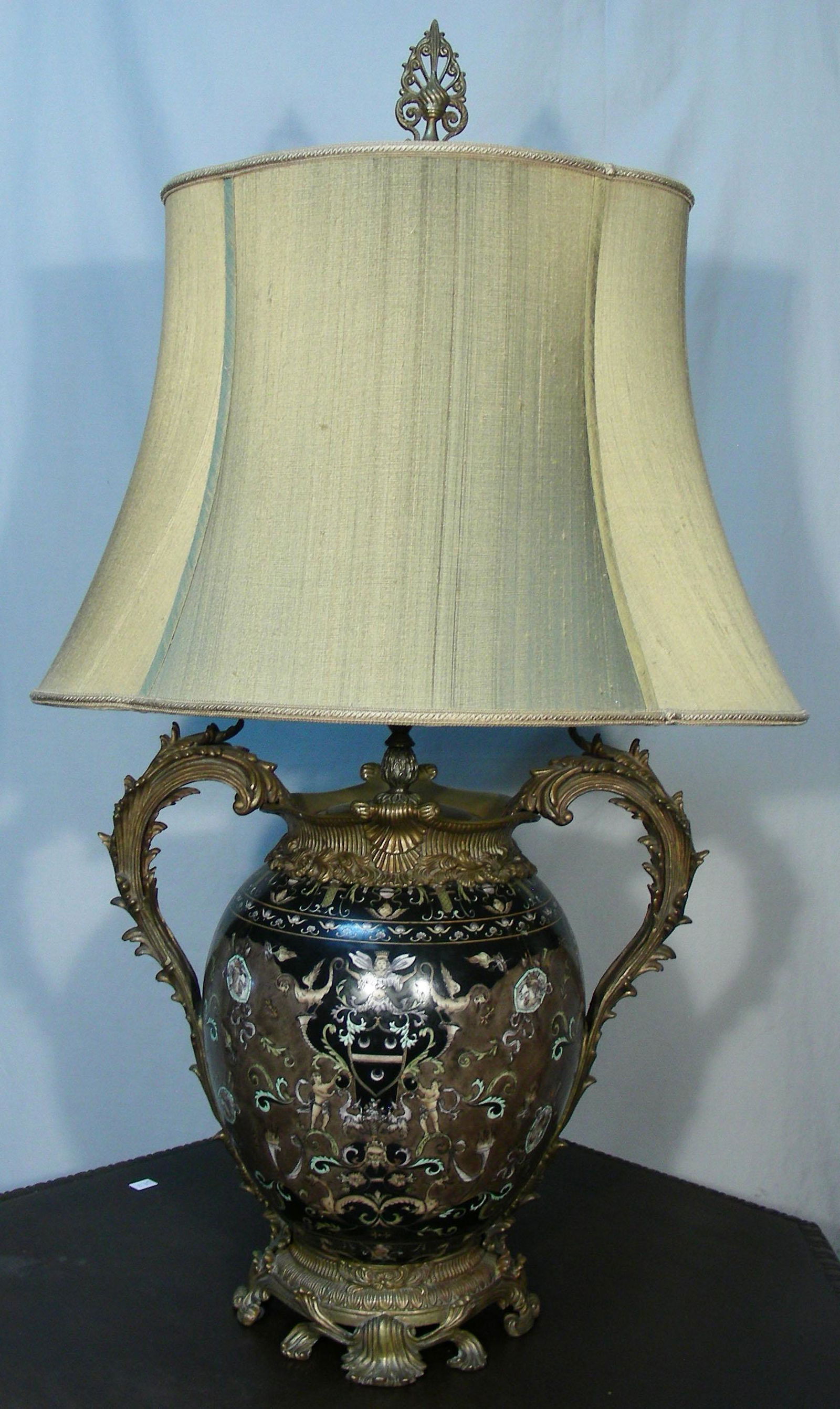 LARGE HAND PAINTED PORCELAIN & BRONZE TABLE LAMP: Hand painted scenes with figures and animals. Black & brown background. 38" high.