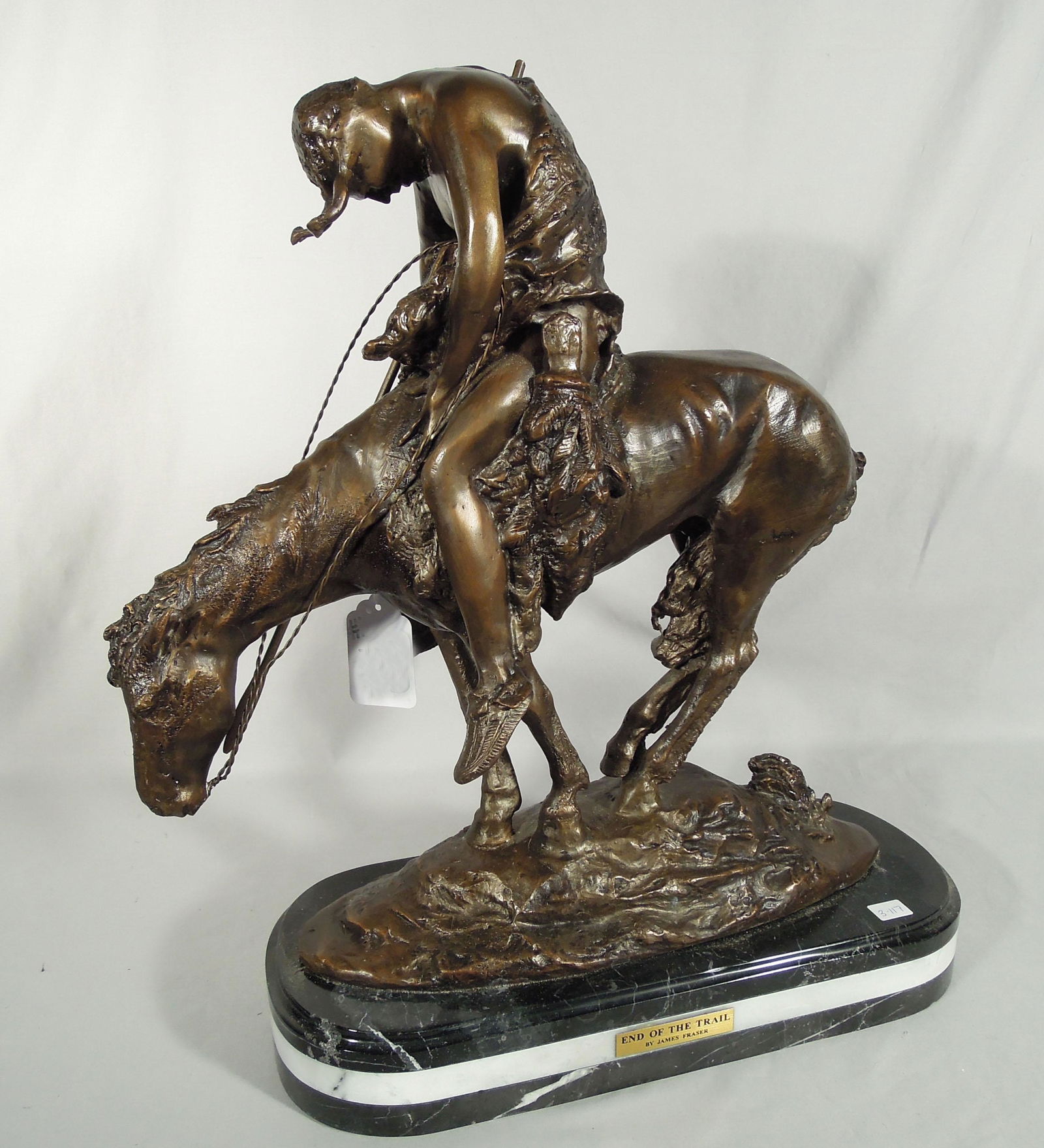 AFTER JAMES EARL FRASER - BRONZE SCULPTURE "END OF THE TRAIL": Signed. Fine detail. Black & white marble base. 21 1/2" high, 20 1/2" wide.