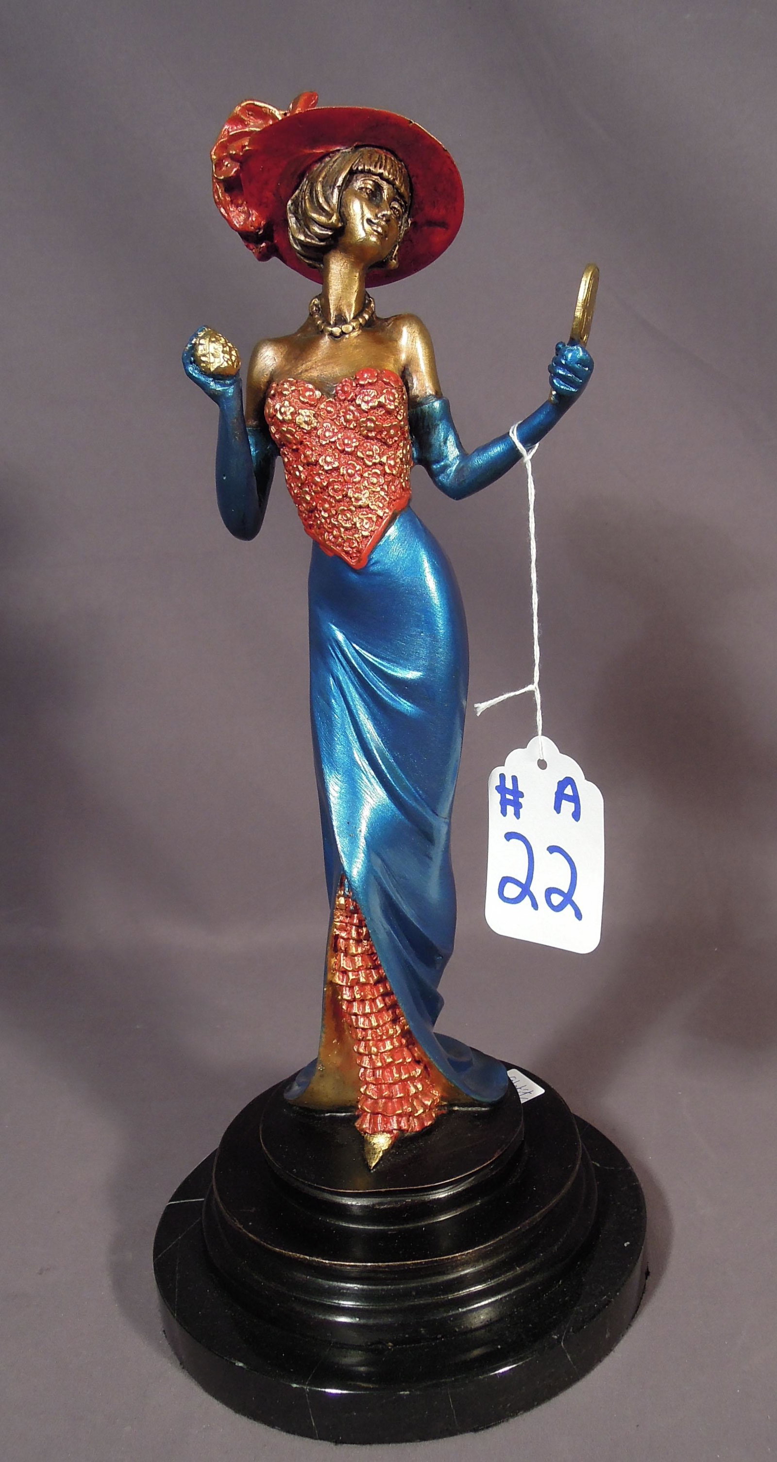 BRONZE SCULPTURE OF FASHION LADY: Lady holds a hand mirror. Multi color patina. 15 1/2" high.