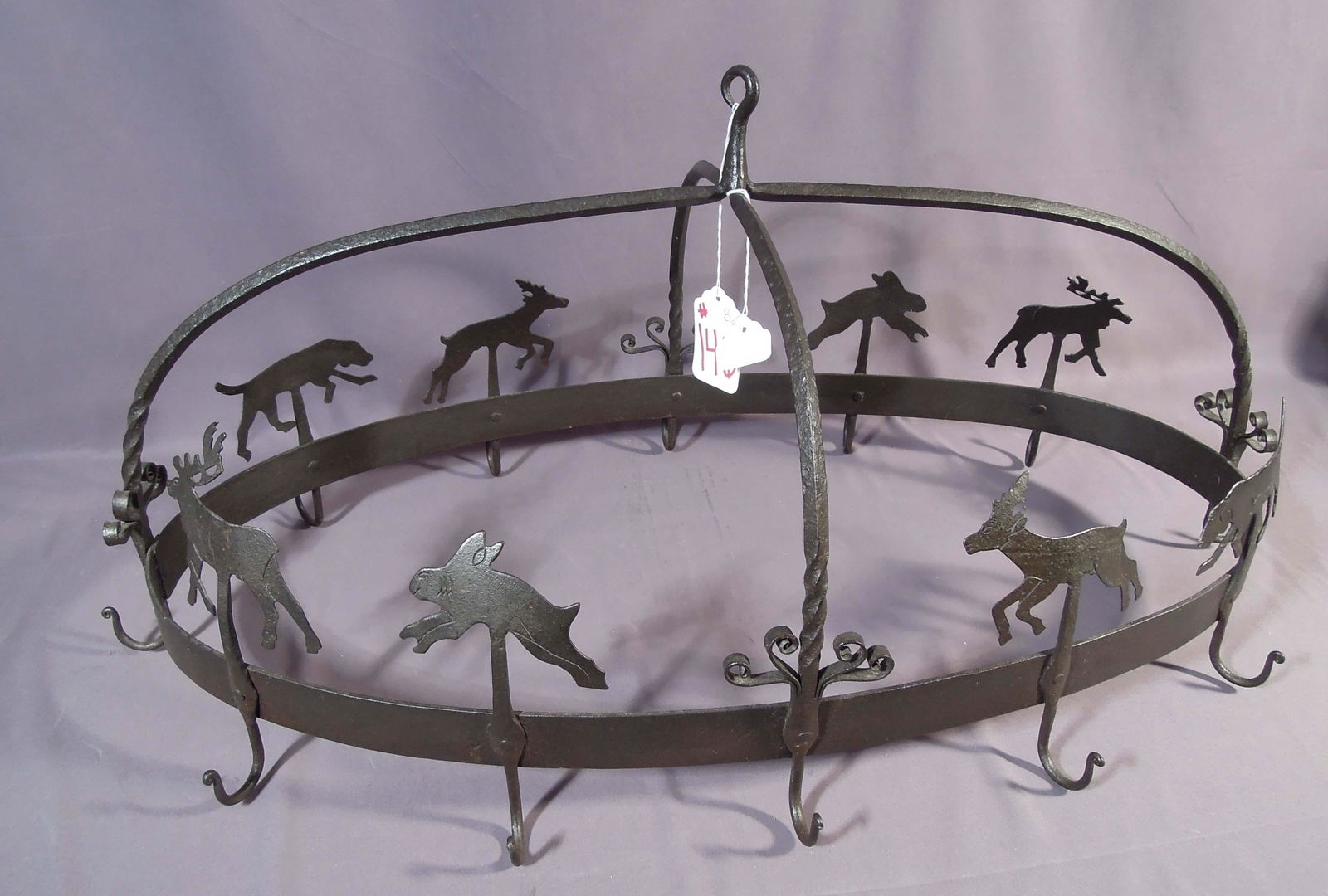 HEAVY CAST IRON POT AND PAN HOLDER: Wild life motif. 16" high, 32" wide.