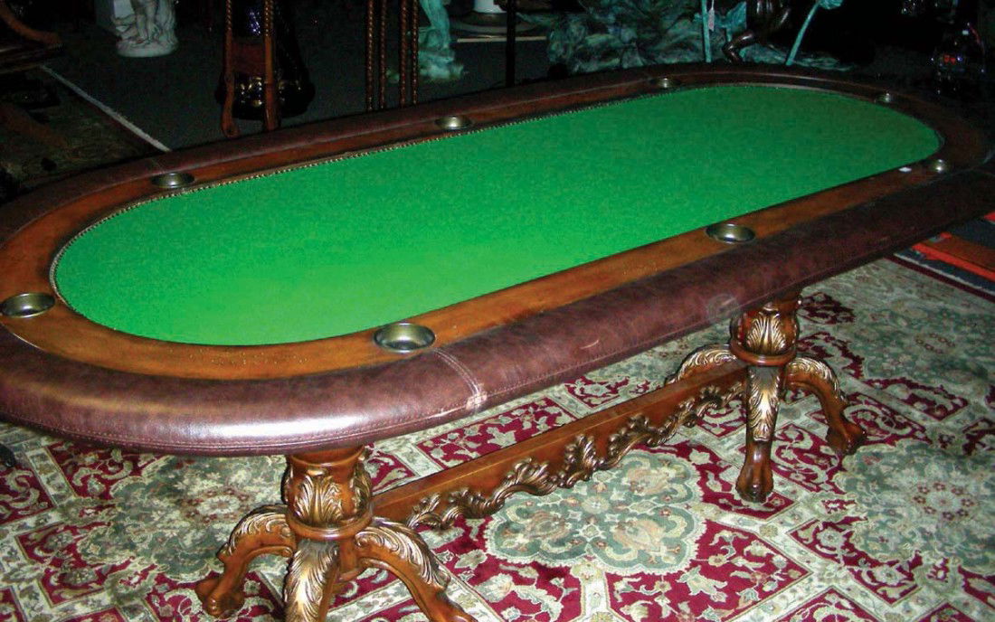 LARGE OVAL SHAPED HAND CARVED WOODEN AND LEATHER PO: LARGE OVAL SHAPED HAND CARVED WOODEN AND LEATHER POKER TABLE - A heavily carved base supports a table with leather border and a green felt top. 31 1/2" high, 93" wide, 43" deep