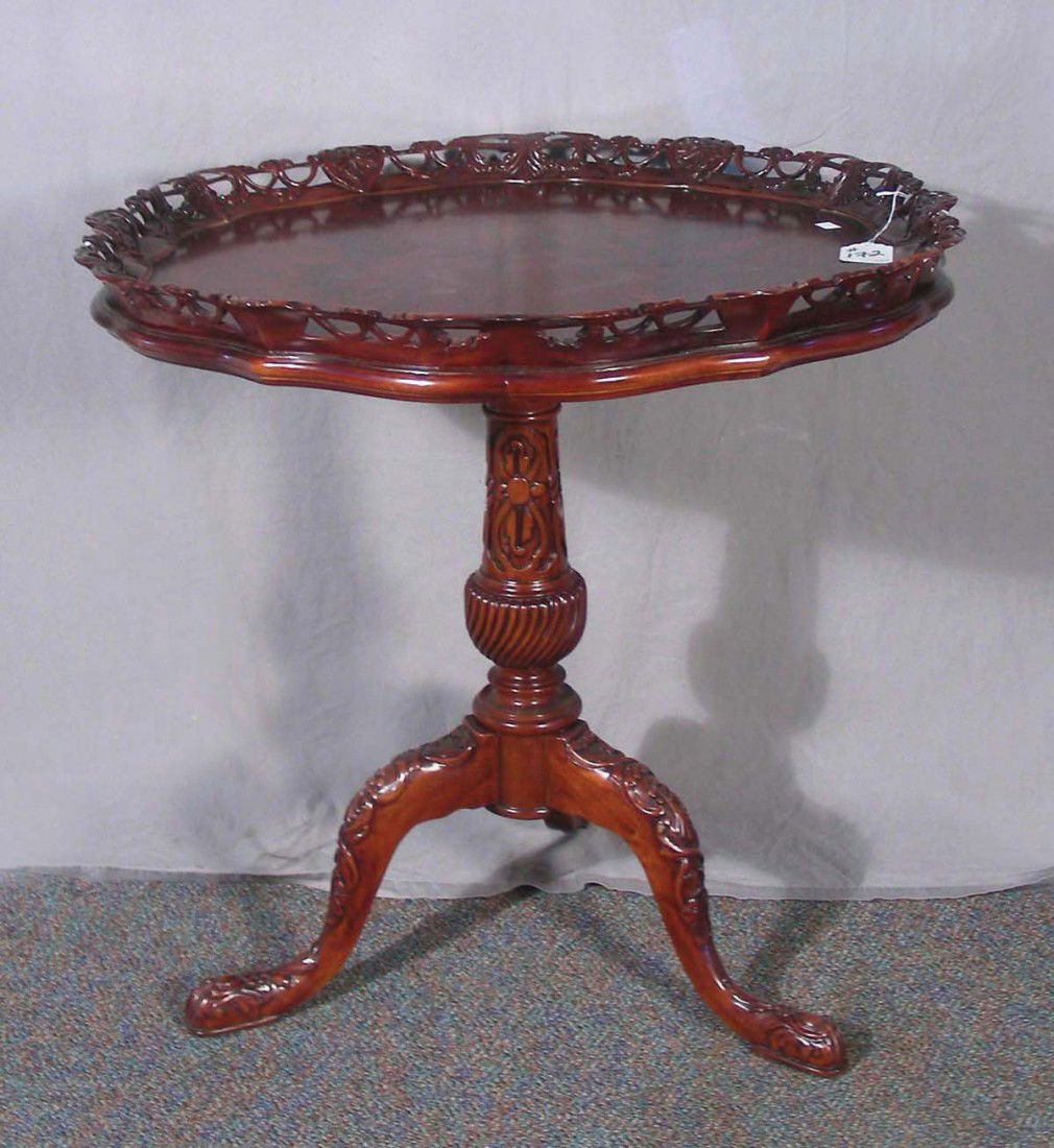 HAND CARVED BURLWOOD MAHOGANY OCCASIONAL TABLE: Tri-footed table with round top. Open work carving. 30" high, 30" dia.