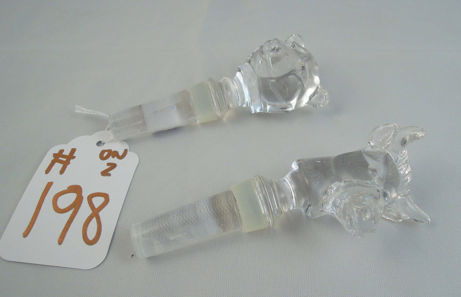 TWO HEAVY CRYSTAL "STOCK MARKET" WINE STOPPERS: Bull and Bear. 4 1/2" high.