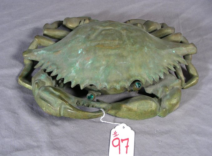 UNUSUAL ANTIQUE BRONZE "CRAB" SPITTOON: UNUSUAL ANTIQUE BRONZE “CRAB” SPITTOON Brown and gold patina. Crab has green glass eyes. Note: Step on crab claw and top of shell opens to reveal a bowl. 15 1/2” wide