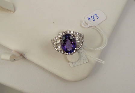 LADIES BEAUTIFUL PLATINUM, TANZANITE & DIAMOND RING: A platinum mount set with a fine oval cut tanzanite weighing 4.50 cts. Ring completed with baguette cut diamonds and full cut round diamonds totaling approx. 1.51 cts. Ring size 7 1/2.