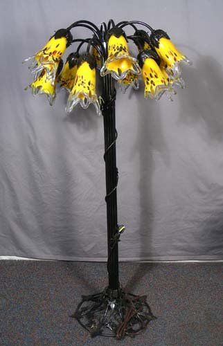HAND BLOWN ART GLASS AND METAL FLOOR LAMP: HAND BLOWN ART GLASS AND METAL FLOOR LAMP 12 curved arms support hand blown art glass shades in yellow, brown and orange coloration. 55 1/2” high, 30” dia.