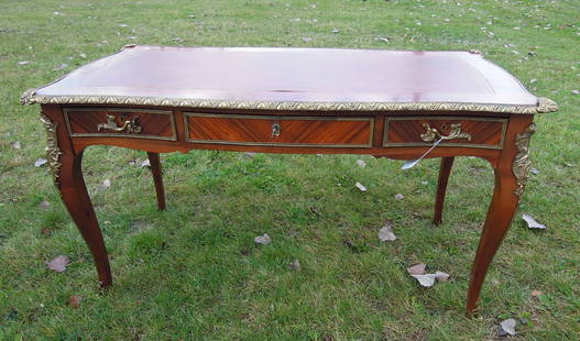 LOUIS XV STYLE FRENCH INLAID WRITING DESK WITH INSET LEATHER TOP: Ormolu appointments. Three drawers. Very good condition. 30" high, 55" wide, 27 1/2" deep.