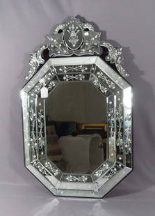 VENETIAN GLASS MIRROR: Beveled mirror with flowrs. Ornate top. Very good condition. 40" high, 27 1/2" wide.