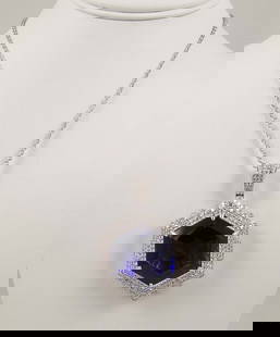 OUTSTANDING LADIES PLATINUM, TANZANITE & DIAMOND NECKLACE: A platinum necklace supports a fabulous hexagonal platinum pendant set with a faceted tanzanite weighing 101.44 cts. Tanzanite with violet blue coloration. Tanzanite surrounded by full cut round