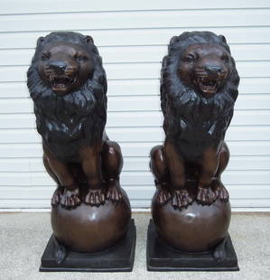 SPECTACULAR PAIR OF BRONZE SEATED LIONS: Majestic left and right sculptures of lions. Excellent detail. Two color patina. 56" high.