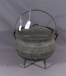 FALKIRK IRON COMPANY ANTIQUE CAST IRON CAULDRON: Three legged cast iron pos embosed on side "Falkirk Size 6" with lid "Size 5". Circa 1900. Signed on lid and on side of pot.