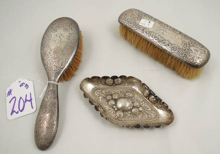 GROUP OF THREE STERLING SILVER ACCESSORIES: Two vintage sterling silver brushes and one sterling silver pin tray.