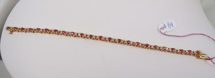 LADIES 14K Y.G., RUBY & DIAMOND ETERNITY BRACELET