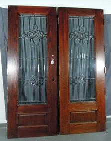 TWO STAINED OAK AND LEADED GLASS DOORS