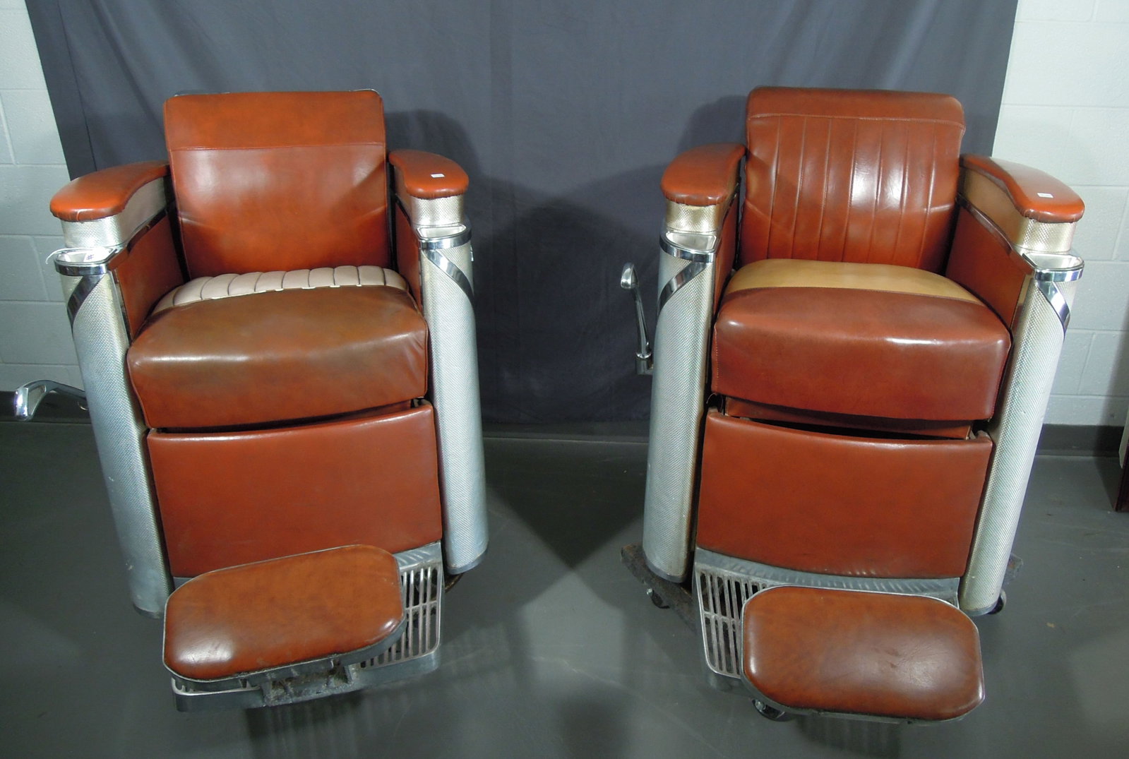 PAIR KOKEN PRESIDENTIAL BARBER CHAIRS: Circa 1950'. Good condition. Both chairs missing headrest.