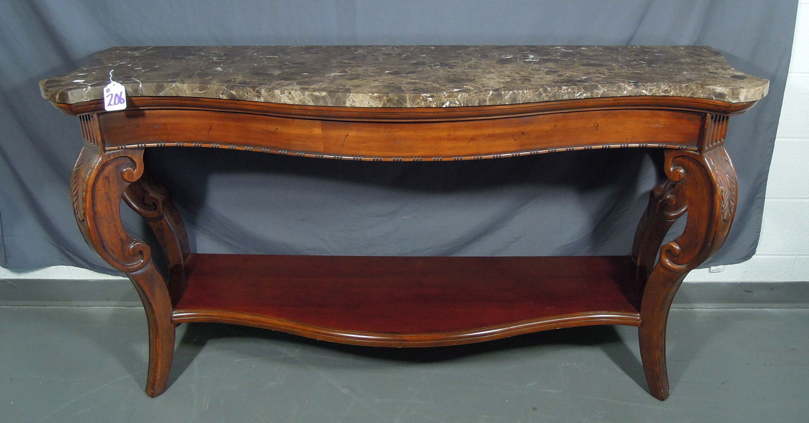 FINE HAND CARVED WOODEN CONSOLE TABLE WITH MARBLE TOP: Large table with single lower shelf and brown marble top. 36" high, 66" wide, 20" deep.
