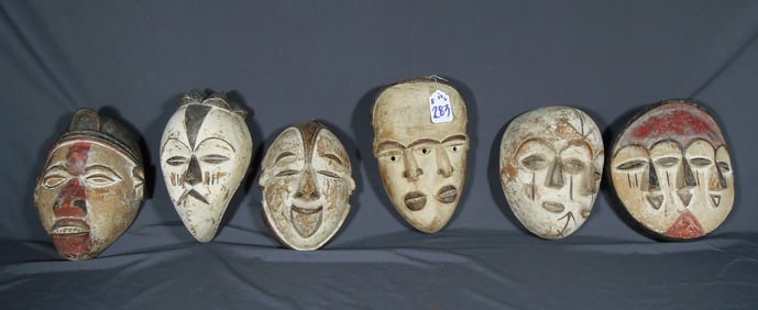 GROUP OF SIX VINTAGE CARVED WOOD AFRICAN MASKS