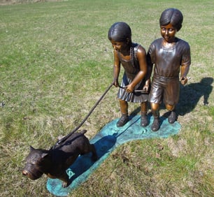 ADORABLE BRONZE SCULPTURE OF TWO CHILDREN WALKING DOG