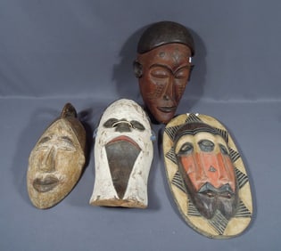 GROUP OF FOUR VINTAGE HAND CARVED WOODEN AFRICAN MASKS
