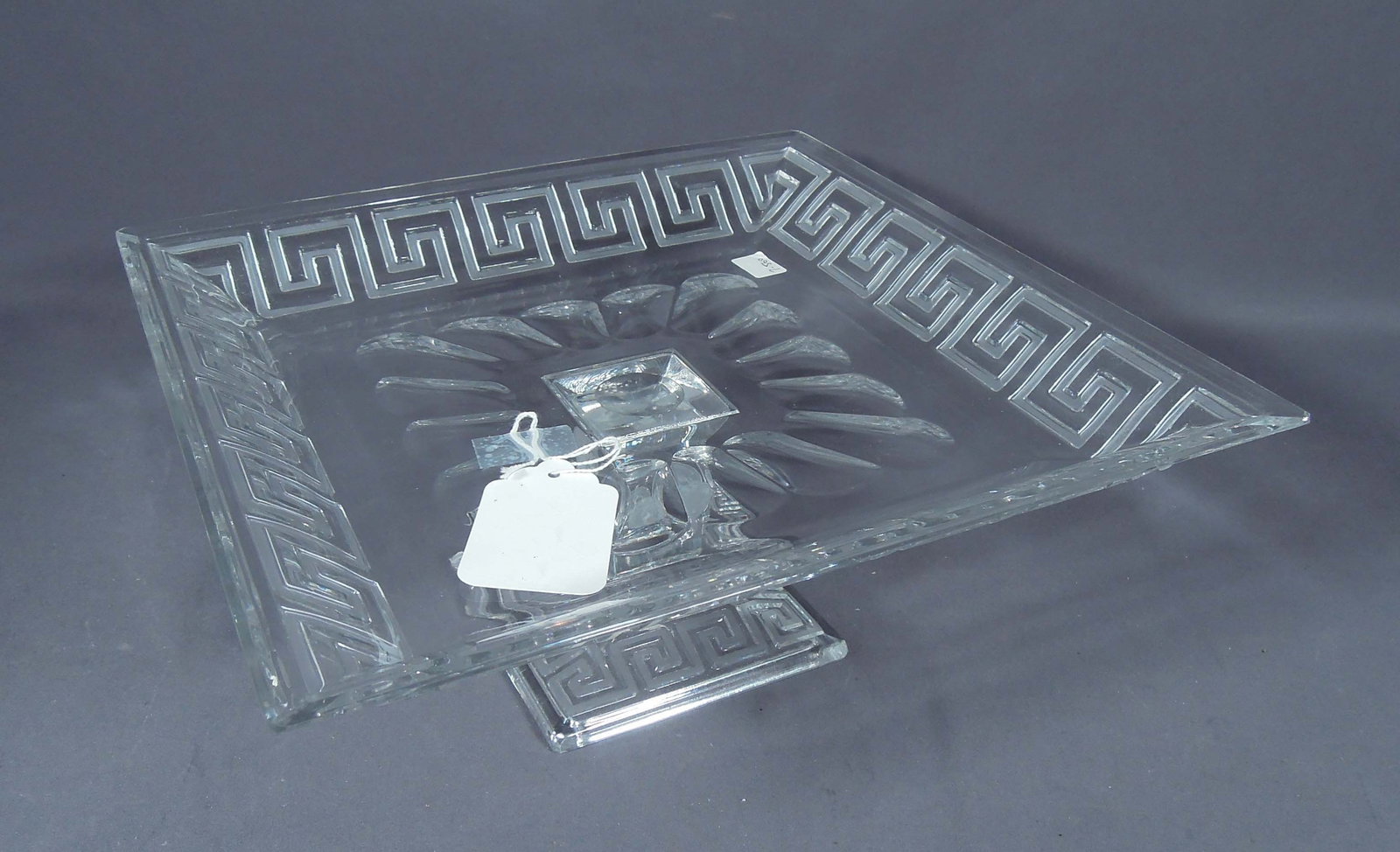 CUT CRYSTAL VERSACE STYLE PEDESTAL TRAY: Greek key design and frosted lions heads on base. 5 1/2" high, 12 1/2" sq.
