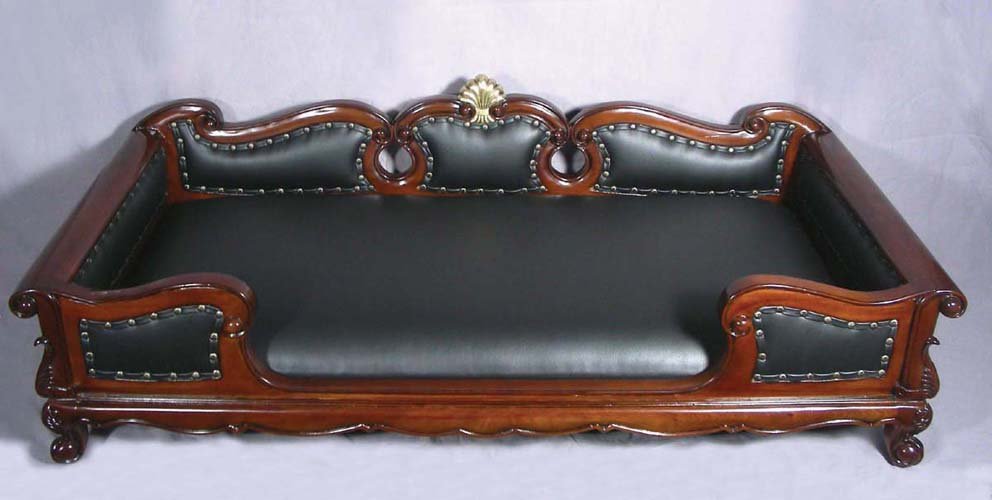 HAND CARVED MAHOGANY AND LEATHER DOG SOFA: HAND CARVED MAHOGANY AND LEATHER DOG SOFA Very fine carving with black leather sofa. 14 1/2" high, 4' wide, 2' deep