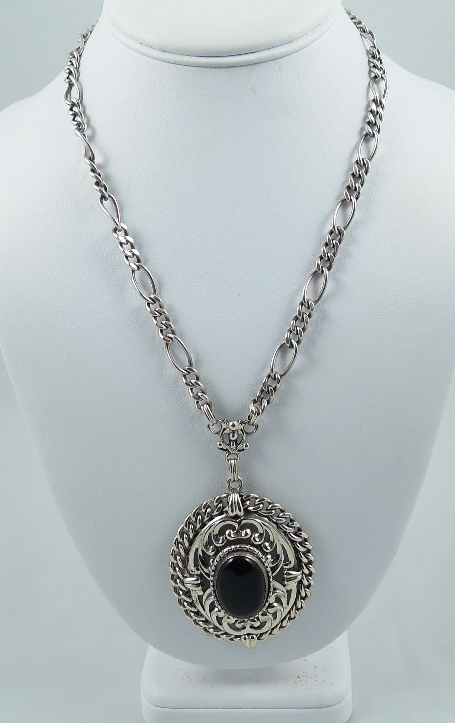 DESIGNER DANECRAFT STERLING SILVER AND ONYX NECKLACE: A link chain supports a large sterling silver pendant set with a large cabochon onyx pendant. Signed. Weighs 58.4 grams.