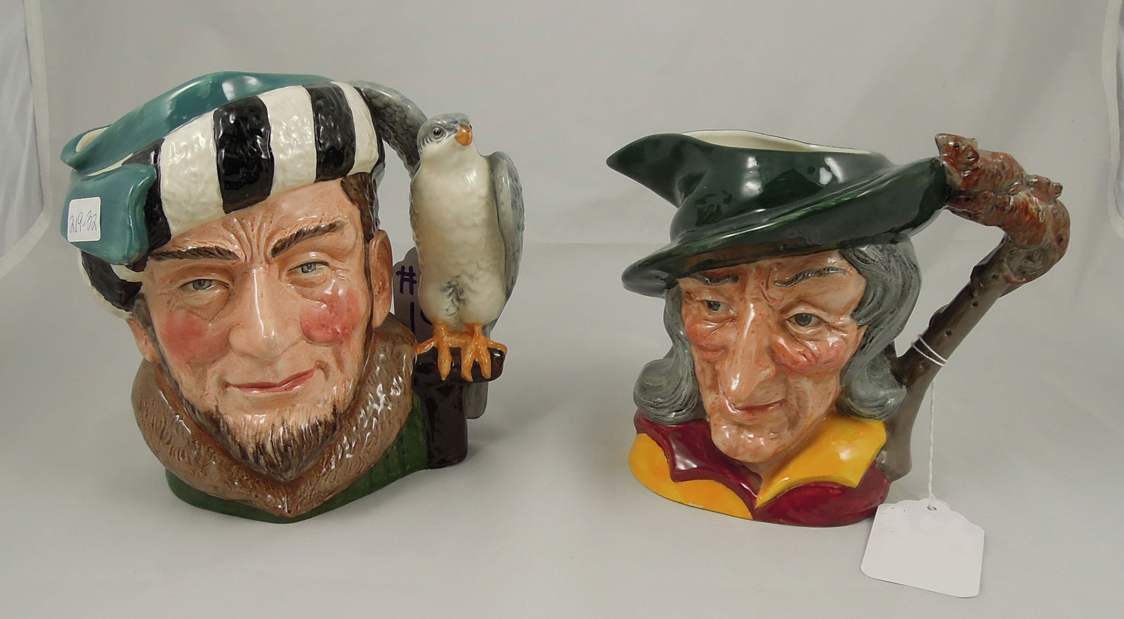 TWO LARGE ROYAL DOULTON TOBY MUGS: Pied Piper #D6403. 6 1/2" high. "The Falconer" #D6533. 7" high. Each in excellent condition.