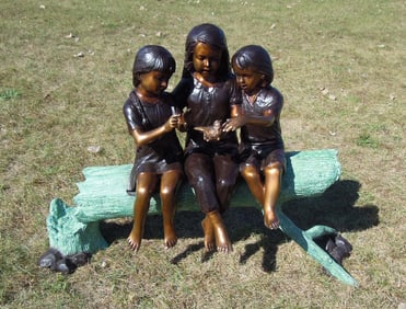 ADORABLE BRONZE SCULPTURE OF THREE YOUNG CHILDREN SEATED ON LOG
