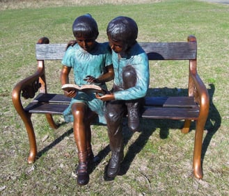 SPECTACULAR BRONZE SCULPTURE OF TWO CHILDREN SEATED ON BENCH