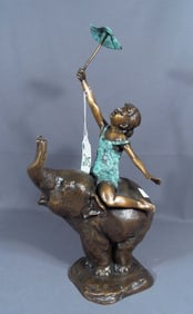 ADORABLE BRONZE SCULPTURE OF YOUNG GIRL SEATED ON ELEPHANT