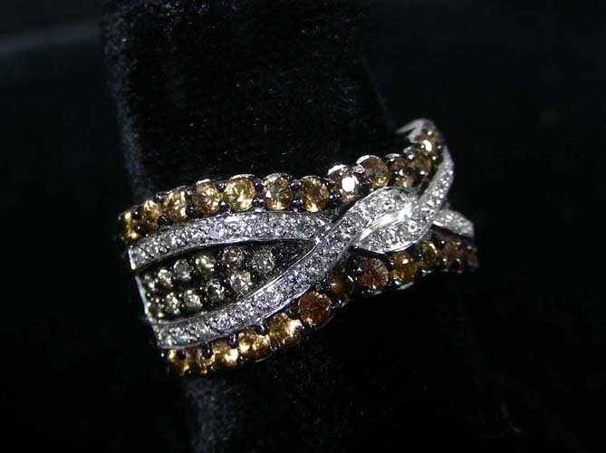 LADIES 14K WHITE GOLD, CHOCOLATE AND WHITE DIAMOND RING: LADIES 14K WHITE GOLD, CHOCOLATE AND WHITE DIAMOND RING A white gold ring supports crisscrossing rows of chocolate diamonds and white diamonds. Total diamond weight approx. 1.60 cts.