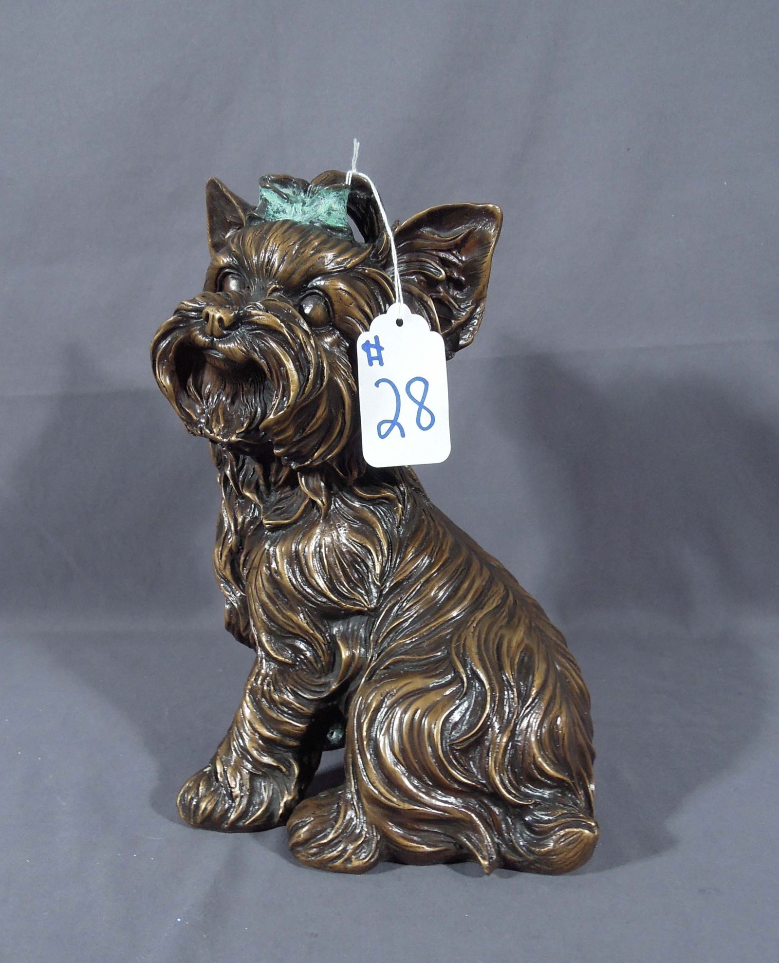 ADORABLE BRONZE SCULPTURE OF YORKIE: Seated Yorkie with bow in her hair. Two color patina. Excellent detail. 12" high, 8" wide, 6" deep.