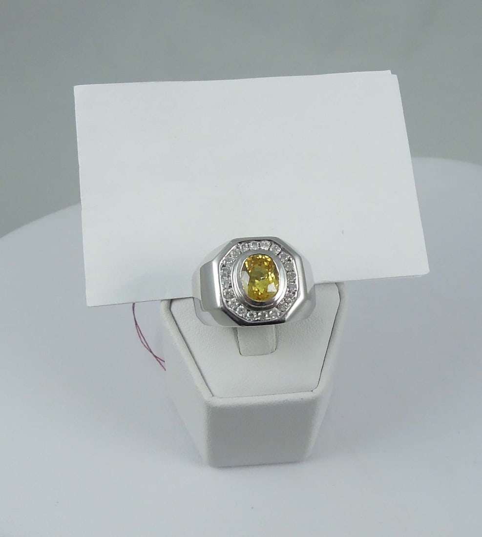 FINE GENTLEMEN'S 14K W.G., YELLOW SAPPHIRE & DIAMOND RING: A highly polished white gold mount set with a beautiful oval cut yellow sapphire weighing approx. 2.75 cts. Sapphiire surrounded by a single row of fine full cut round diamonds totaling approx. .54 ct