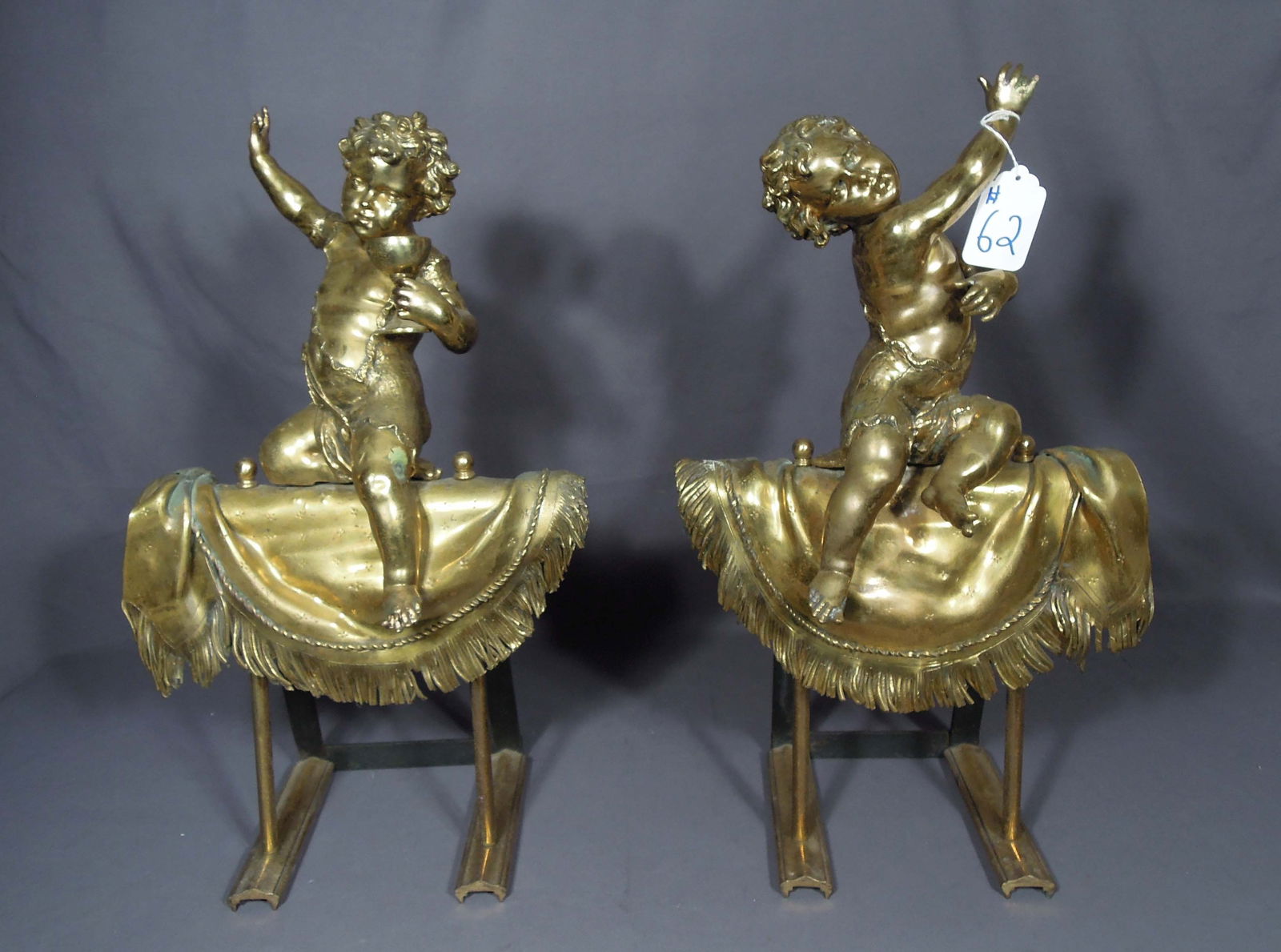 PAIR OF ANTIQUE GILT BRONZE FIREPLACE CHERUB CHENETS: Very heavy. 23 1/2" high, 13" wide, 11 1/2" deep.
