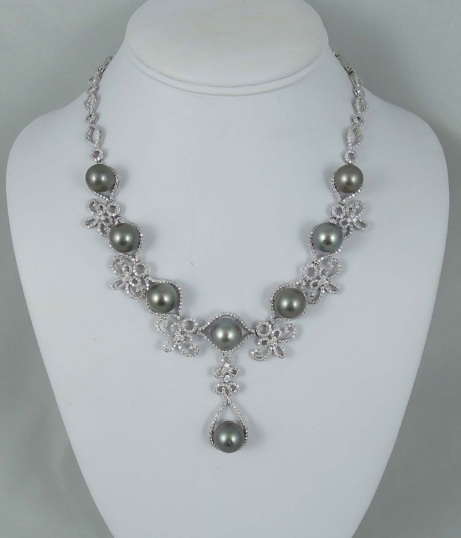 BEAUTIFUL LADIES 14K W.G., BLACK TAHITIAN SOUTH SEA PEARL & DIAMOND NECKLACE: An open work white gold necklace set with very fine Tahitian black South Sea pearls measuring 11 1/2-12mm. Necklace encrusted with full cut round diamonds totaling approx. 9.48 cts. Necklace weighs 51