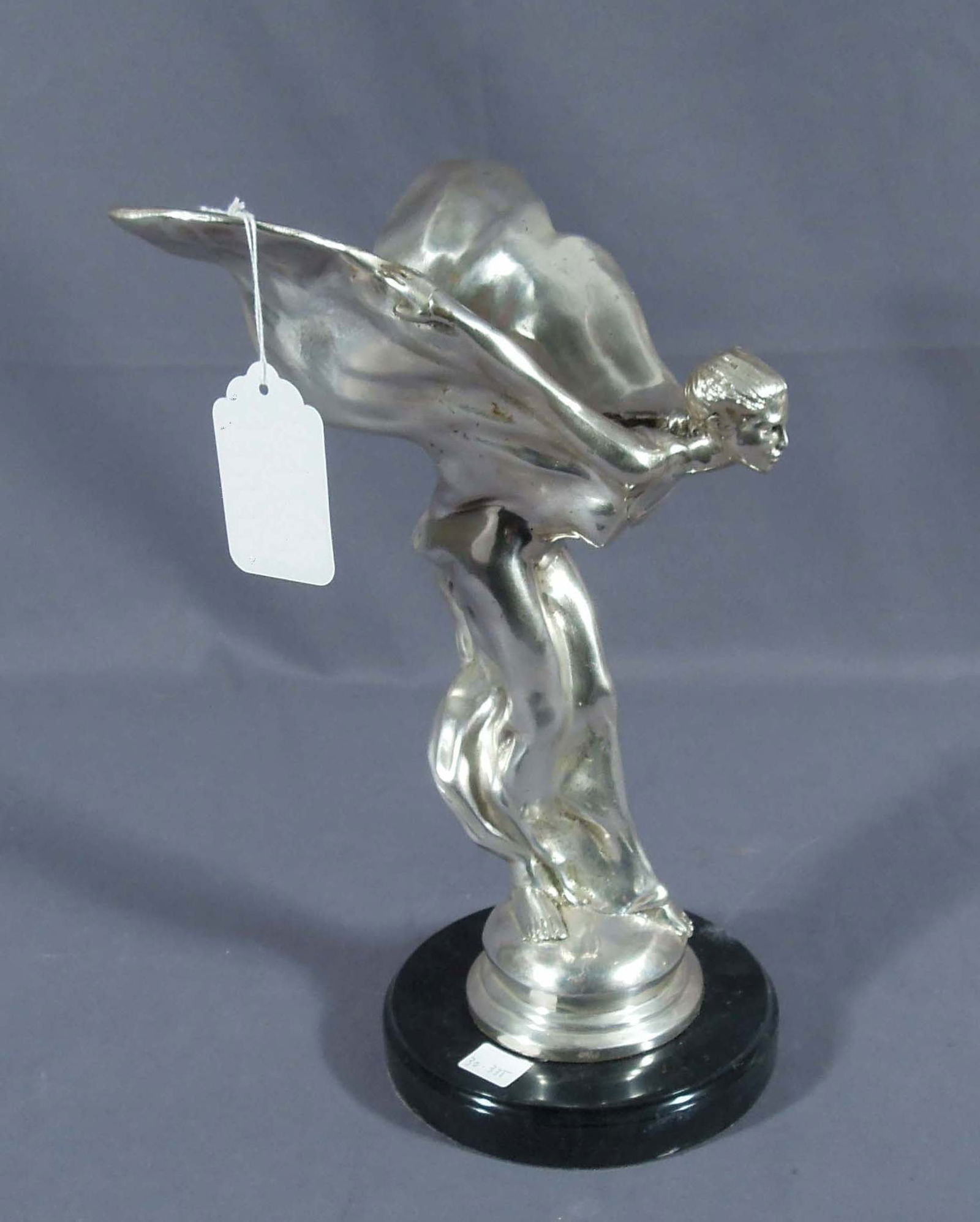 BRONZE SCULPTURE "SPIRIT OF ECSTASY": Also known as "Rolls Royce Girl". Silver patina. Black marble base. 13" high, 8" wide, 8" deep.