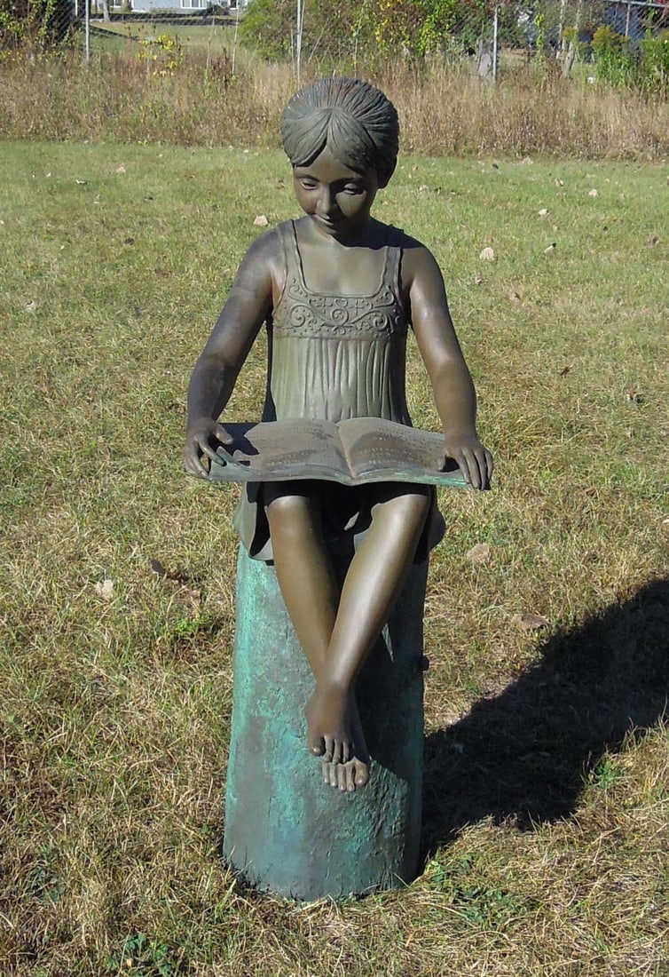 HEAVY VINTAGE BRONZE SCULPTURE OF YOUNG GIRL SEATED ON STUMP WHILE READING BOOK: Great aged patina. 41" high, 15" wide, 21" deep.