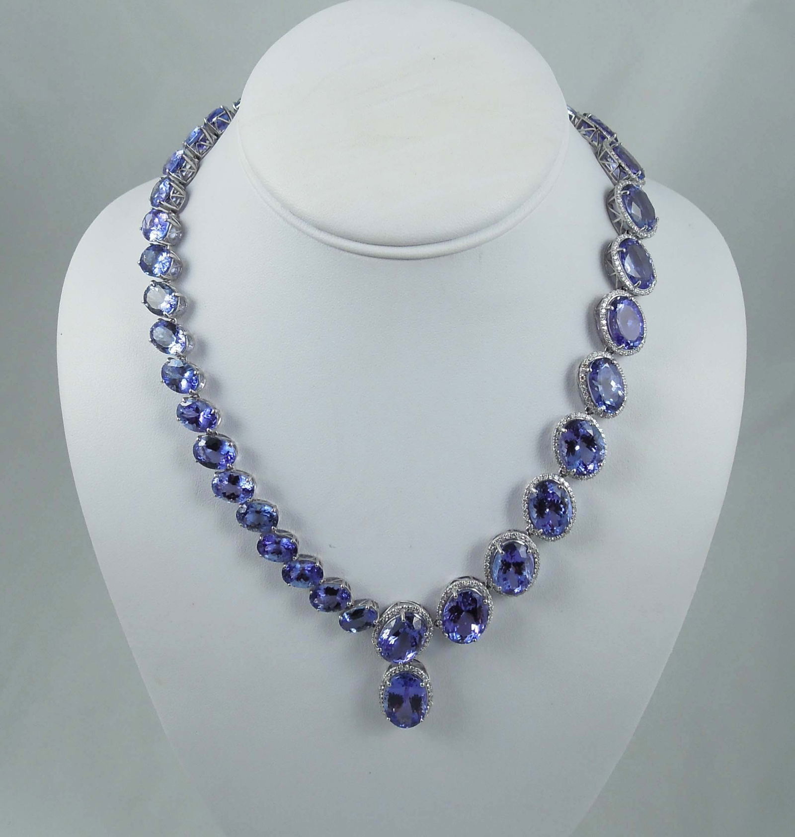 SPECTACULAR LADIES PLATINUM, TANZANITE & DIAMOND NECKLACE: An eternity style necklace set with 38 oval cut tanzanite totaling approx. 198 .80 cts. Violetish bue colorations with excellent cut grade. Many tanzanite surrounded by a single row of full cut
