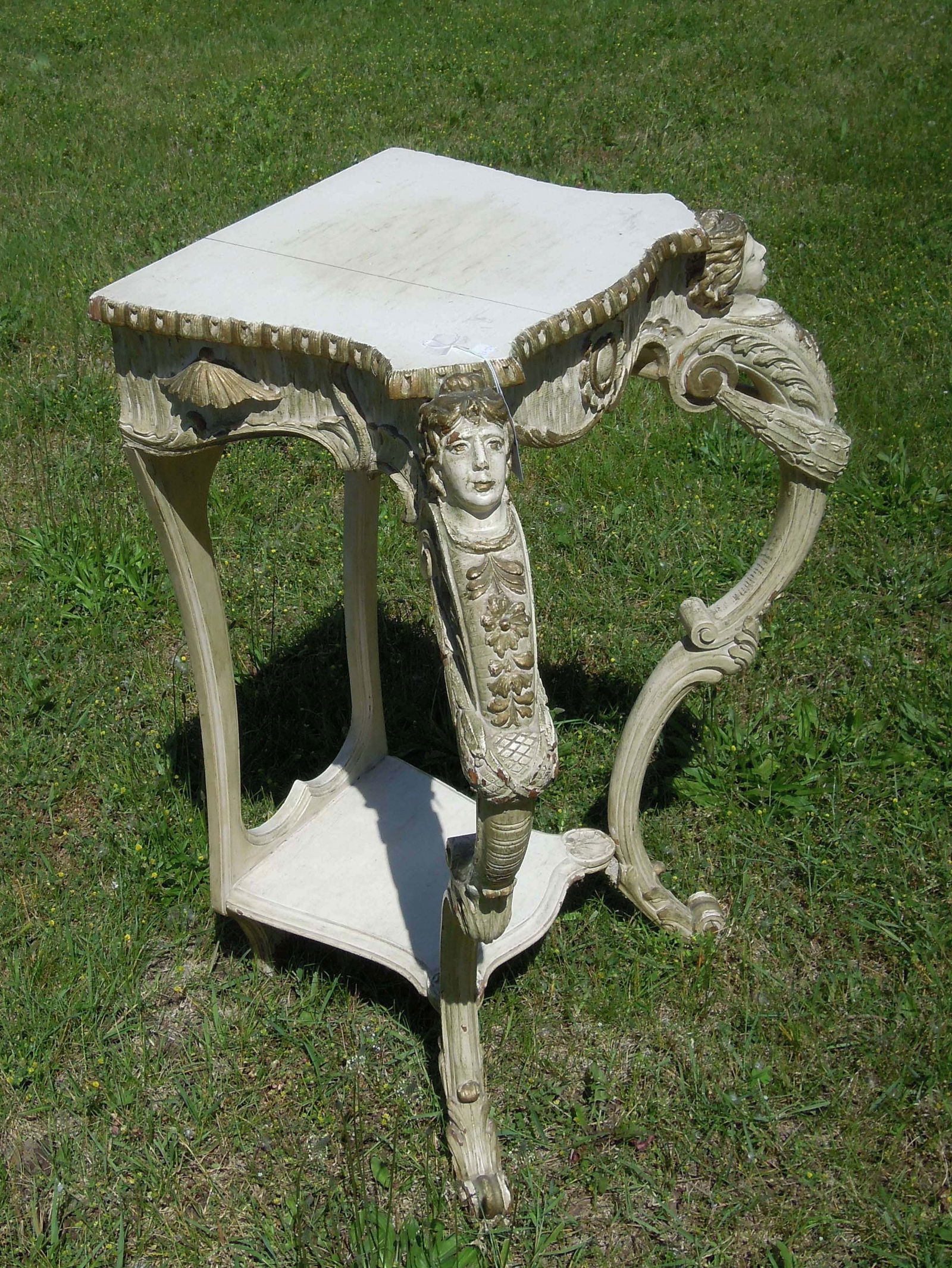 ANTIQUE HAND CARVED FIGURAL TABLE: 34" high, 25" wide, 17 1/2" deep.
