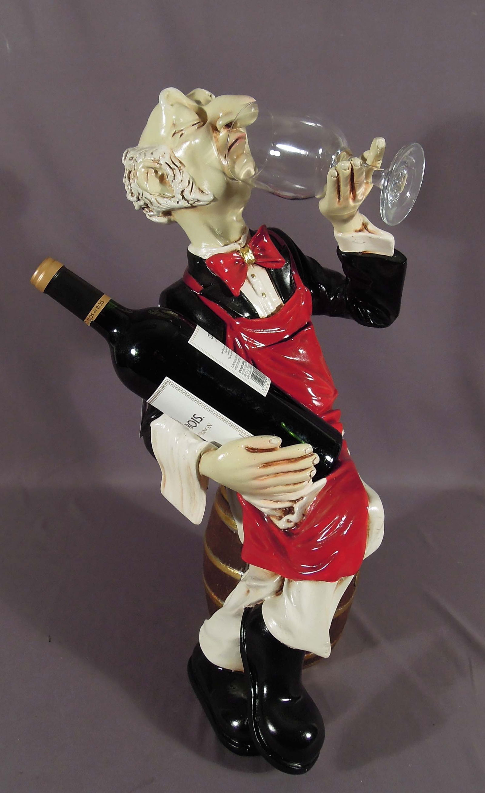 HAND PAINTED COMPOSITION SCULPTURE OF WINE SNOB: He holds a glass in one hand and bottle in other. 23" high.