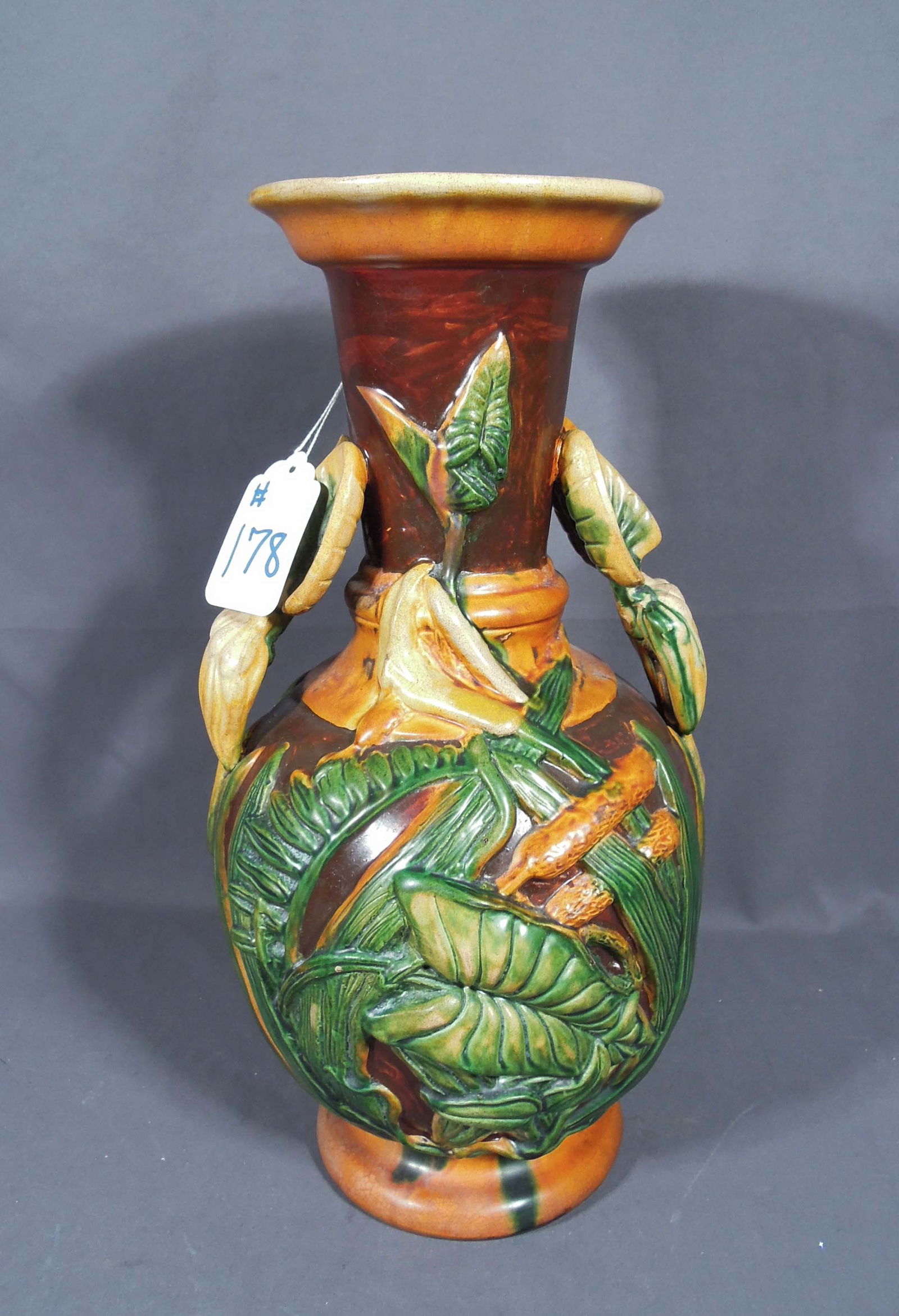 ART NOUVEAU STYLE FAIENCE GLAZED VASE: Raised fruit and leaf motif. 16 1/2" high, 9" dia.