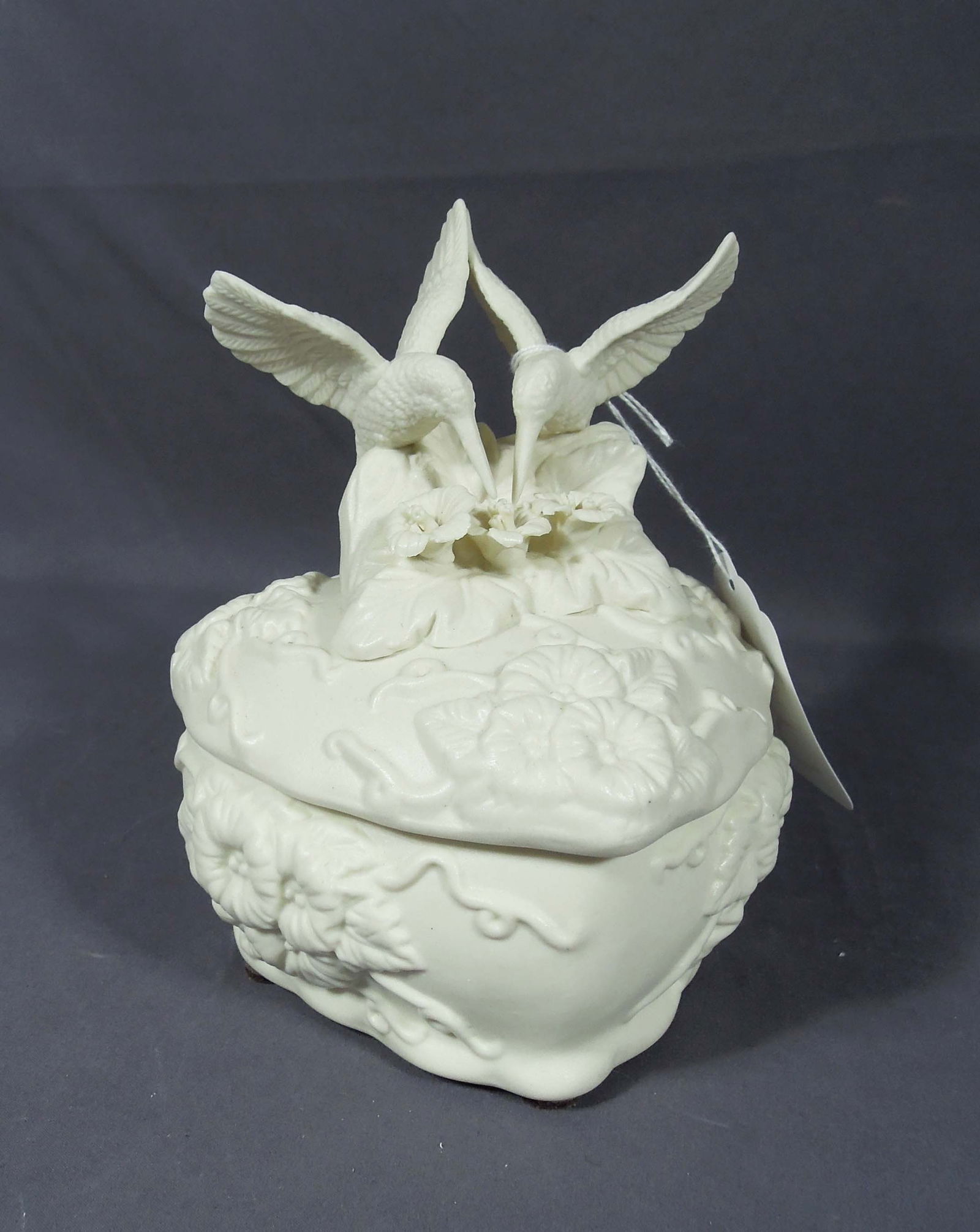 BISQUE HEART SHAPED BOX WITH TWO HUMMINGBIRDS: Lift off top. Excellent condition. 7" high, 6" wide, 5" deep.