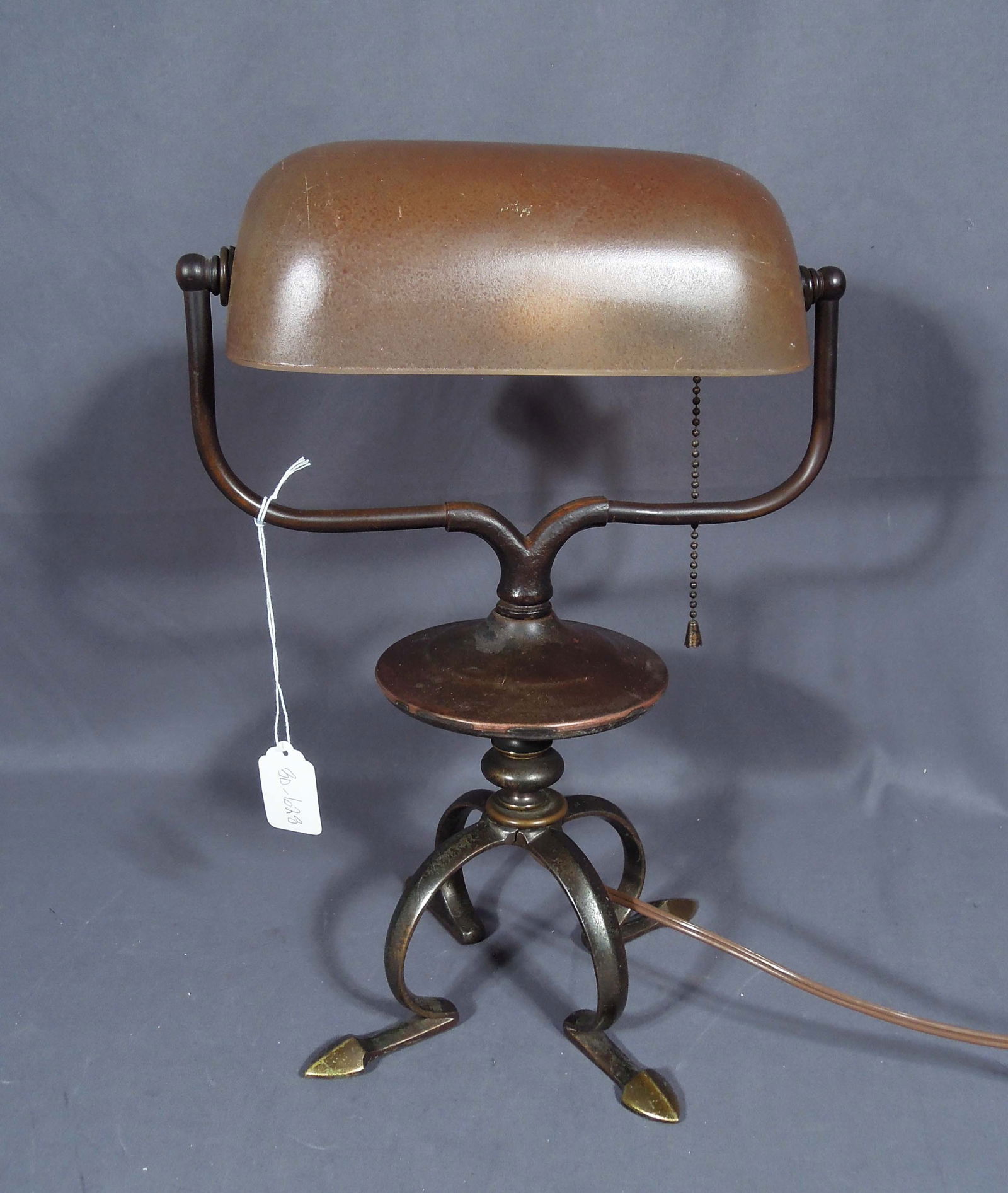 VINTAGE PATINATED METAL & FROSTED AMBER GLASS BANKER'S LAMP: Harp base. Adjustable shade. 15" high, 10 1/2" wide, 6" deep.