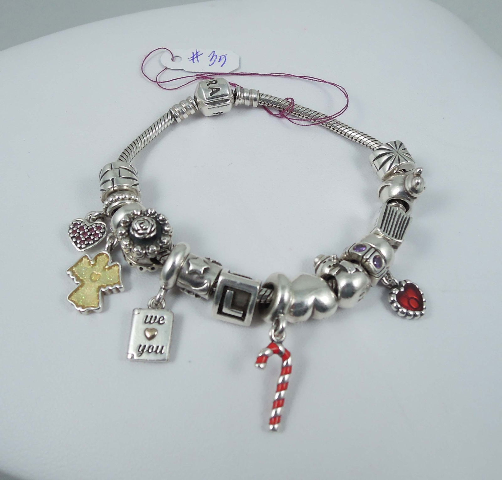 LADIES STERLING SILVER PANDORA BRACELET WITH CHARMS: Signed. 15 charms. Weighs 58 grams.