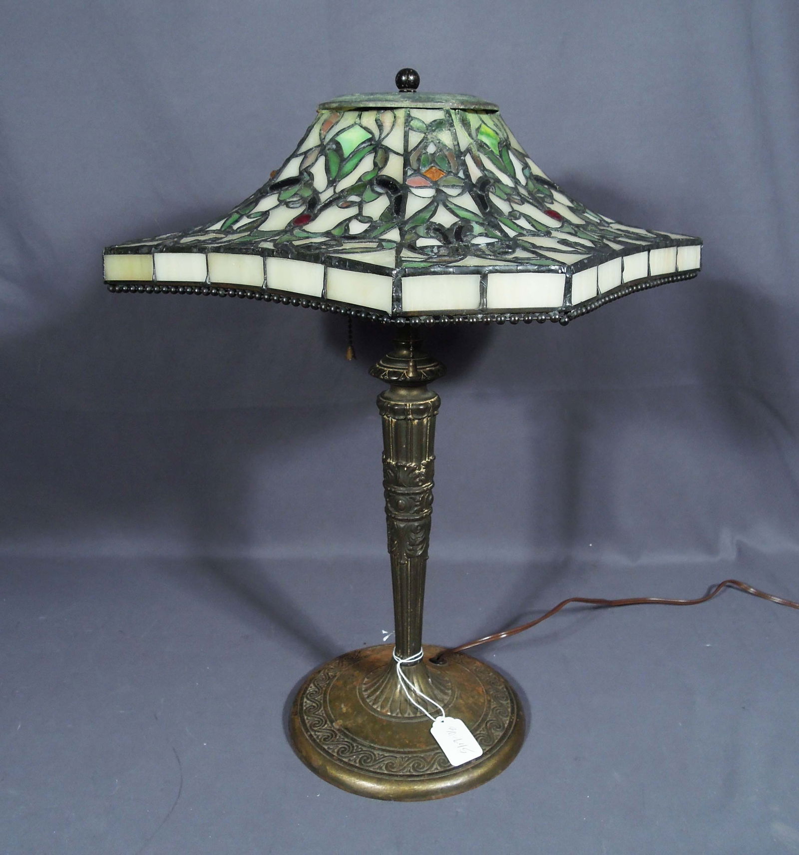 VINTAGE TIFFANY STYLE METAL AND LEADED GLASS TABLE LAMP: A vintage base supports a beautiful unusual hexagonal leaded glass shade. 20" high, 14" sq.