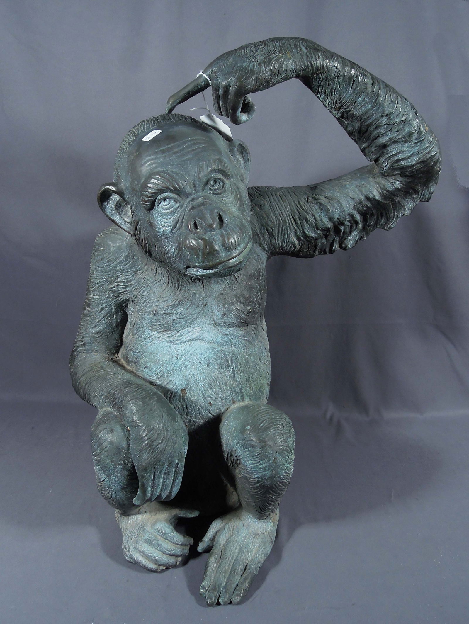 HUMOROUS VINTAGE LIFE SIZE BRONZE SCULPTURE OF SEATED MONKEY: A heavy life size bronze monkey points finger at his head. Great aged patina. 27" high, 19 1/2" wide, 13" deep.