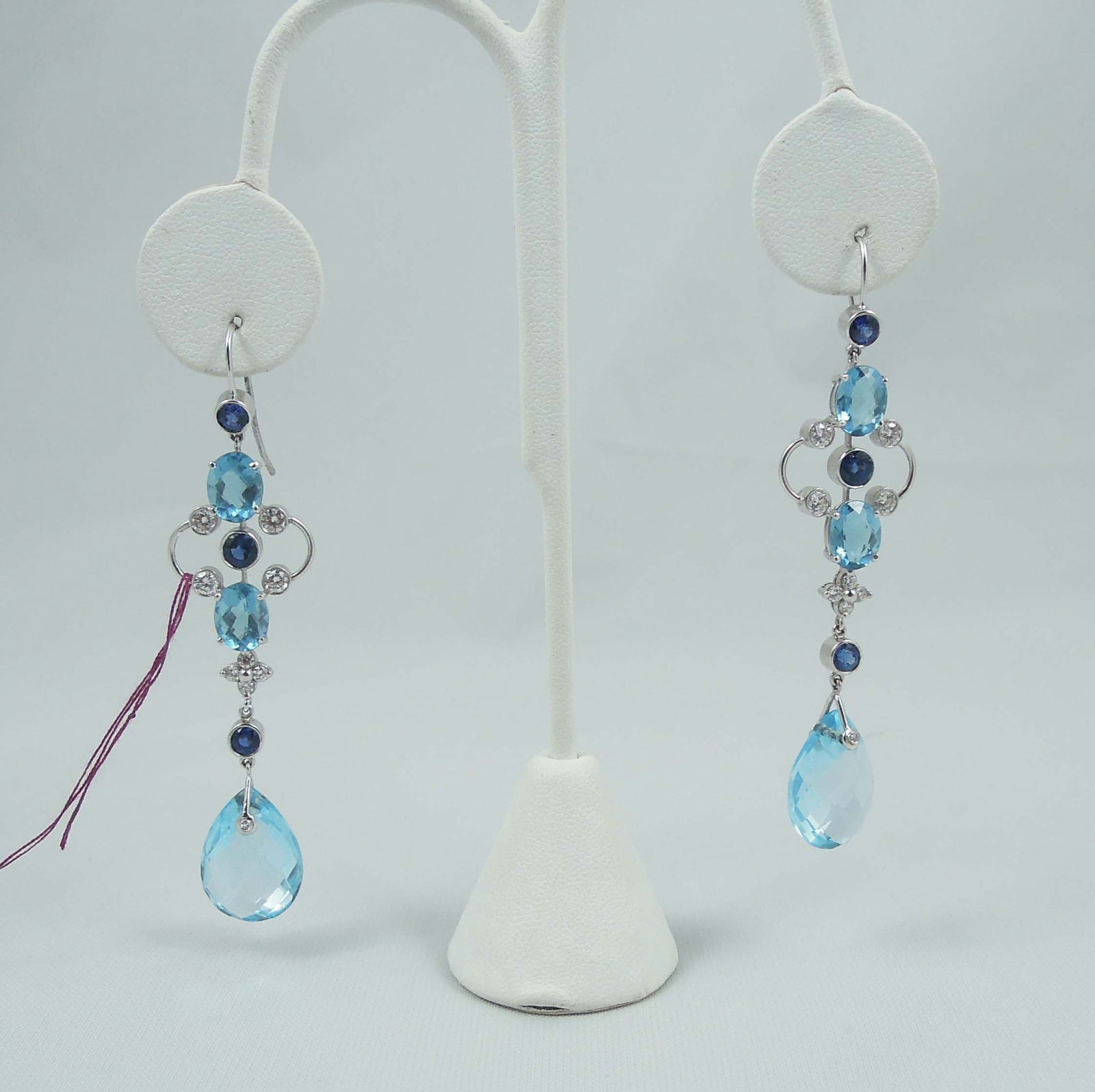 PAIR LADIES 18K W.G., BLUE TOPAZ, SAPPHIRE & DIAMOND DANGLE EARRINGS: Total blue topaz weight approx. 25 cts. Total sapphire weight approx. .50 ct and total diamond weight approx. .30 ct. Earrings measure 2 3/4" long.