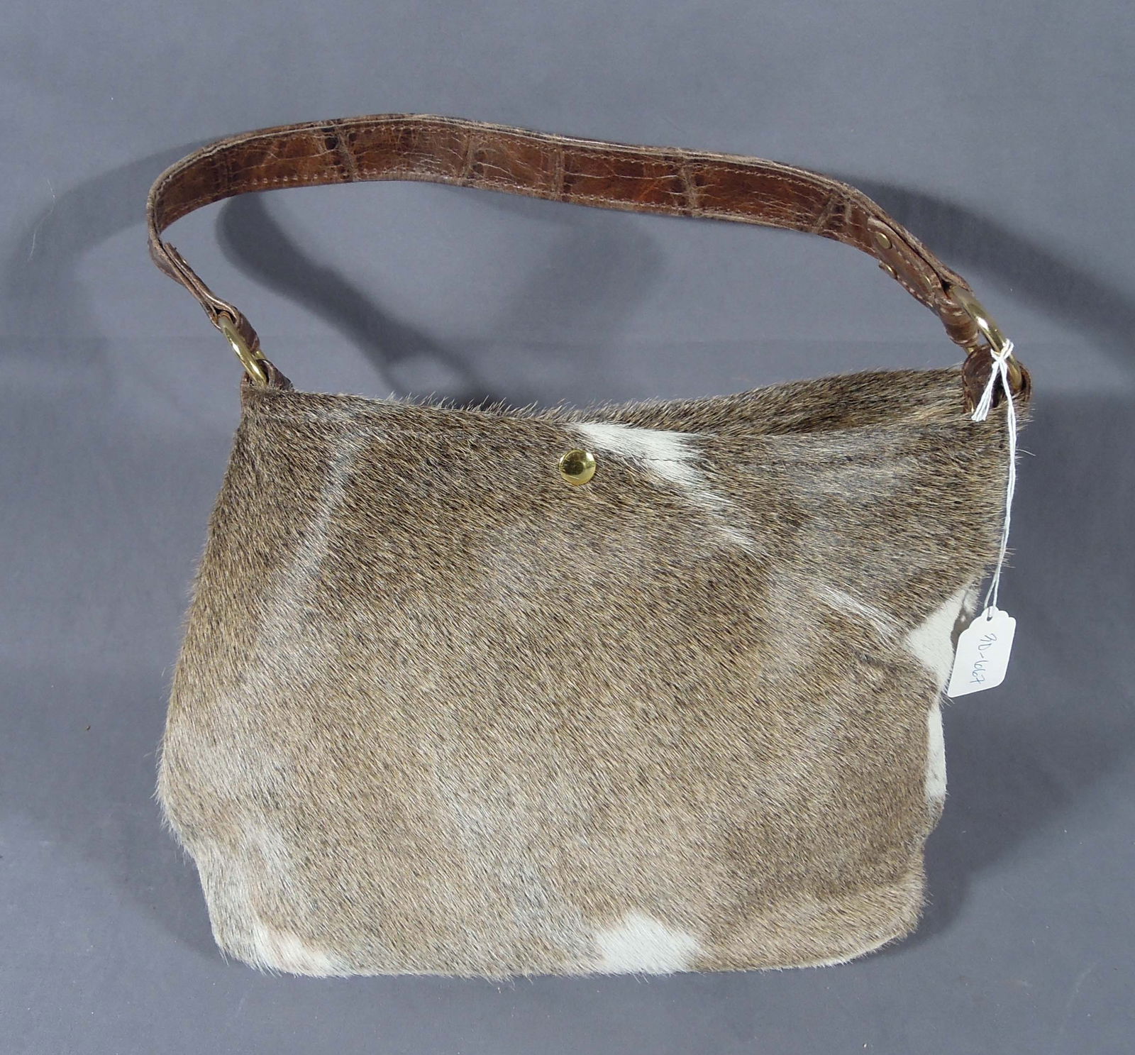HAND CRAFTED COW HIDE BABY BUCKET PURSE: Excellent quality. Brand new. 9 1/2" high, 14" wide.