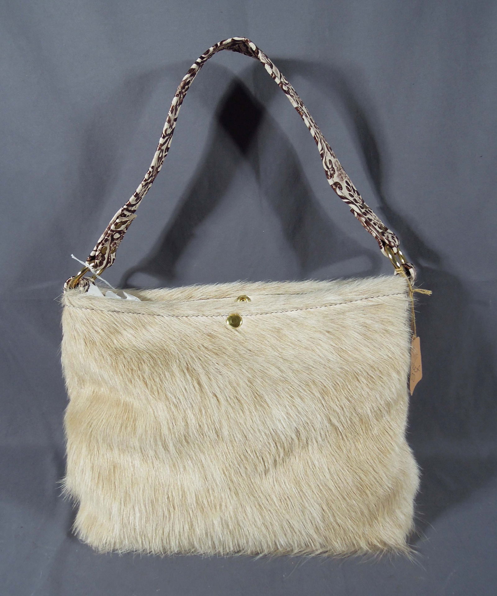 HAND CRAFTED COW HIDE BABY BUCKET PURSE: Excellent quality. Brand new. 9 1/2" high, 14" wide.