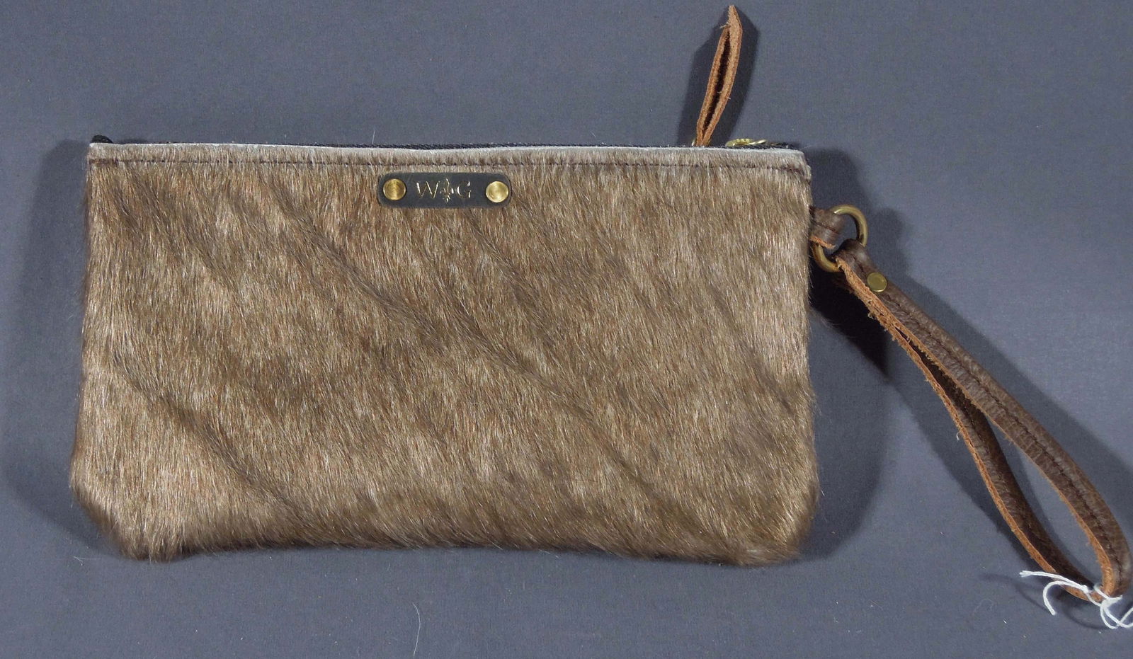HAND CRAFTED COW HIDE WRISTLET: Brand new & excellent quality. 5 1/2" high, 10" wide.
